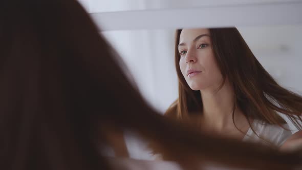 Woman Looking at Mirror at Home