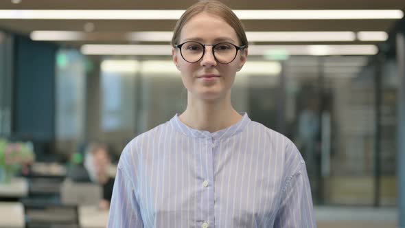 Portrait of Serious Young Woman Looking at the Camera