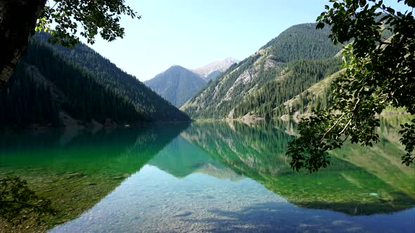 Time laps lake in the mountains, Transparent emerald green water like a mirror
