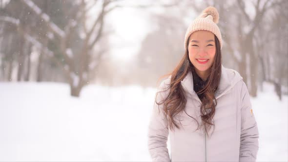 Young asian woman enjoy smile around snow and winter