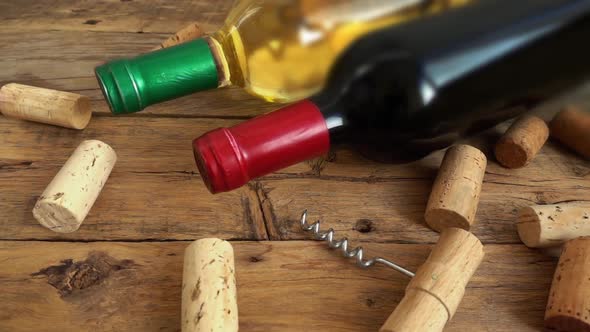 Wine bottles on an old vintage wooden board and falling corks.