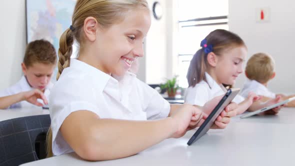 School kids using digital tablet in classroom