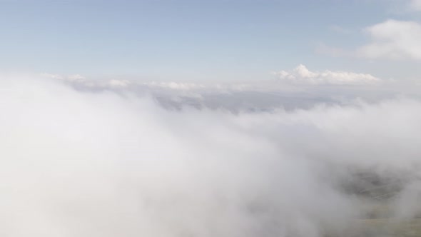 Scenic aerial view of moving white clouds at Abuli Mountain. Georgia