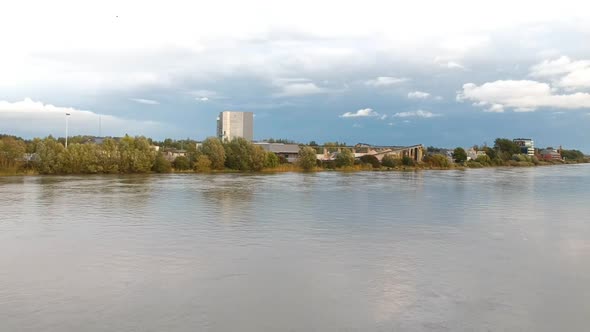 Drone rises over Schelde river and buildings in Antwerp Belgium