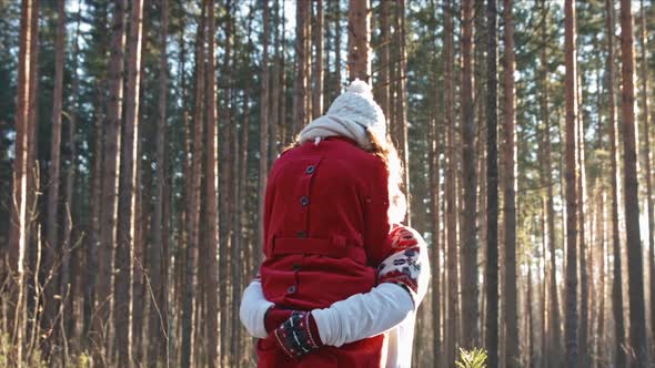 Happy Young Couple Dating in Winter Forest. Xmas Holidays Concept, Family Weekend Spend Time