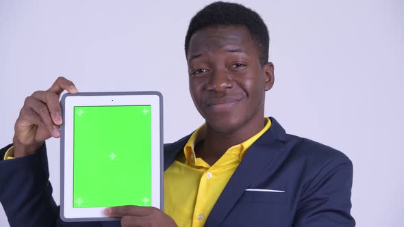 Face of Young Happy African Businessman Showing Digital Tablet