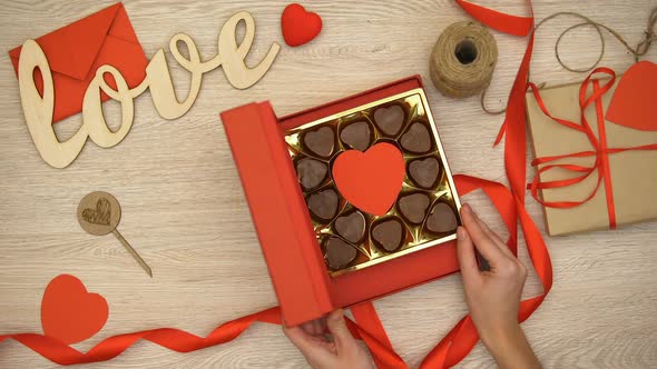 Lady Opening Valentines Giftbox With Heart-Shaped Chocolate Candies, Aphrodisiac