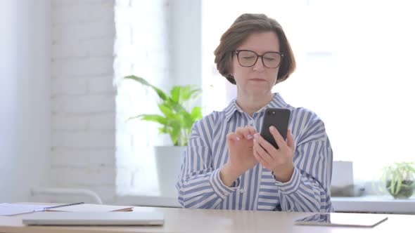 Upset Senior Woman Reacting to Loss on Smartphone