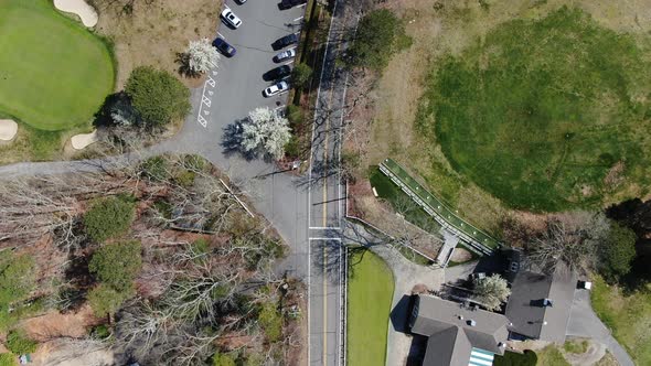 Main building of luxury golf field in America, aerial drone tilt up view