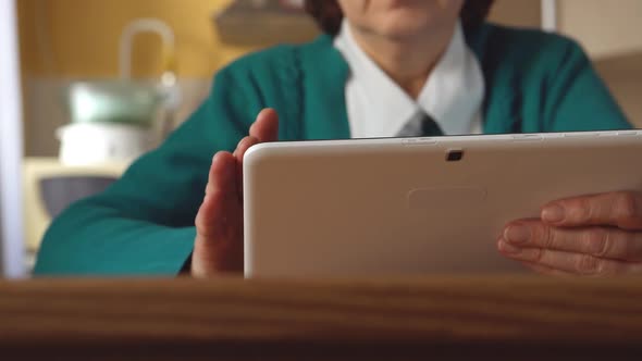 White Tablet Pc In A Mature Woman Hands