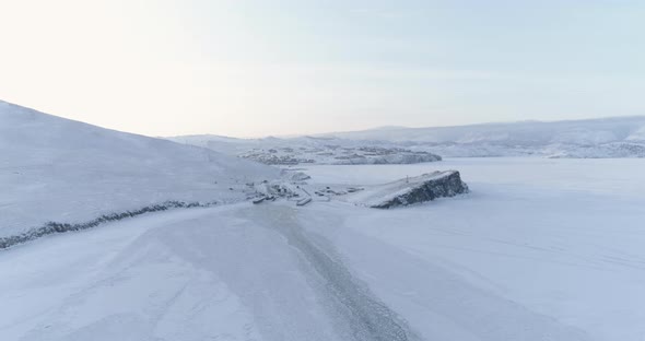 Drone Flies Over the Trail Left by a Ship on the Ice of a Frozen Lake Baikal