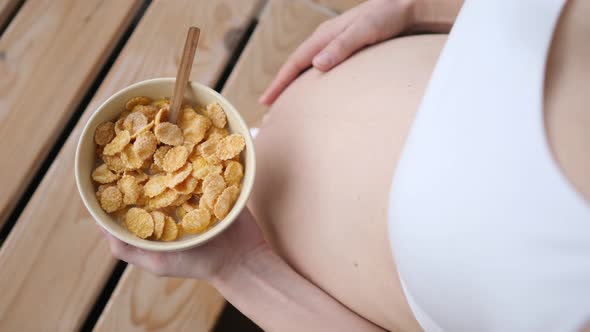 Pregnant Woman Having Tasty and Nutritious Breakfast Cereals.