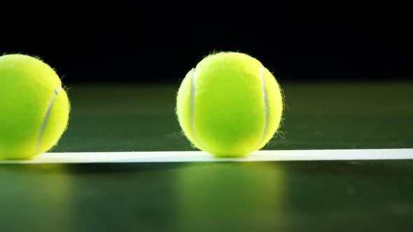 Tennis balls arranged on white line 4k