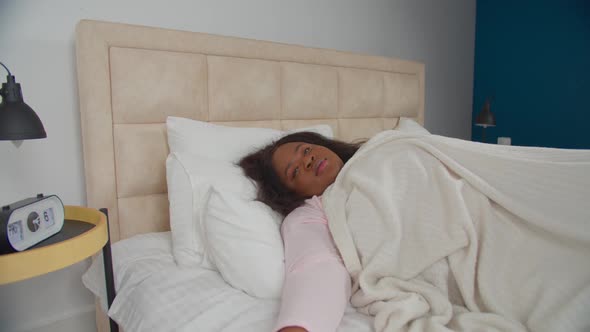 Relaxed Cheerful Woman in Bed Smiling After Awake