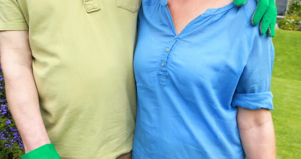 Senior couple standing in backyard