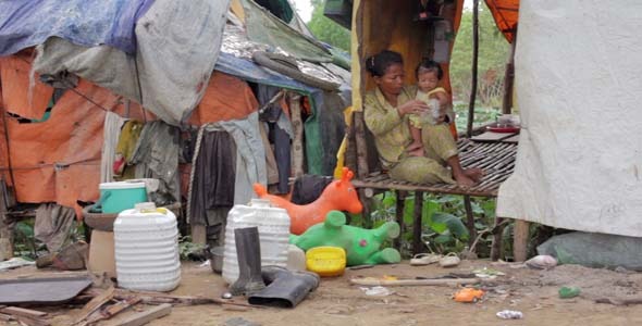 Mother Feeding Baby In Cambodian Slums alt