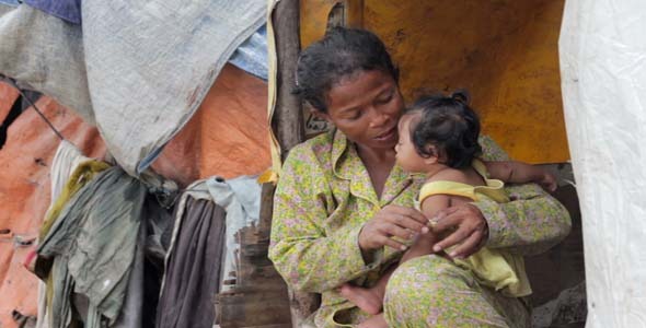 Mother Feeding Baby In Cambodian Slums