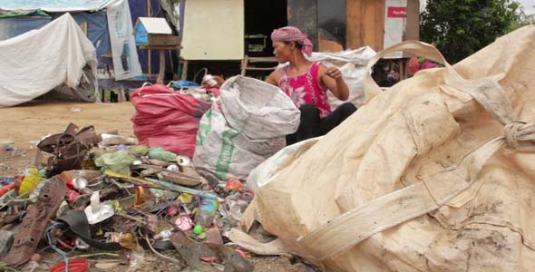 Garbage Gatherers Assorting Trashes In Slums