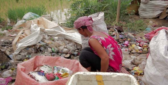 Garbage Gatherers Assorting Trashes In Slums