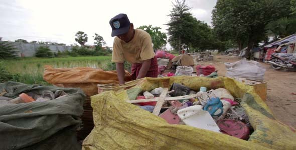 Garbage Gatherers Assorting Trashes In Slums