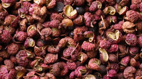 Dried szechuan or sichuan pepper  close up full frame as background 