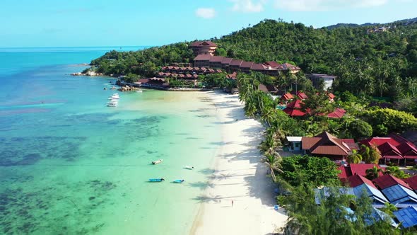 Aerial view landscape of relaxing island beach wildlife by turquoise ocean and bright sandy backgrou