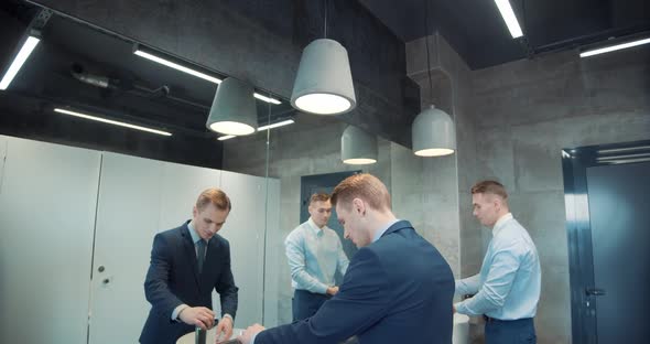 Two Business Man in Office Bathroom