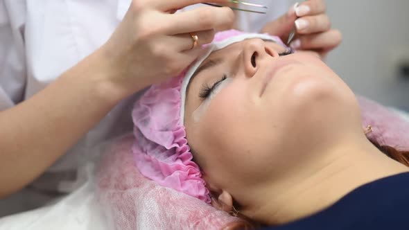 Professional Beautician Undergoing Eyelash Extension Procedure