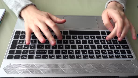 The girl working at home office hands on keyboard.