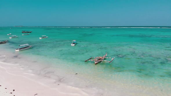 Boats are Anchored Off the Coast on Shallow Ocean at Low Tide Aerial Zanzibar
