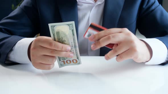 Footage of Young Businessman Choosing Using Credit Card Instead of Paper Dollar Bill