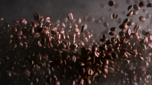 Super Slow Motion Shot of Exploding Premium Coffee Beans and Smoke Isolated on Black at 1000Fps