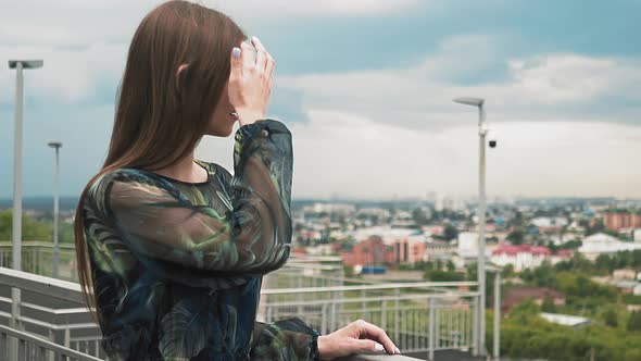 Tranquil Woman in Cute Dress Enjoys Large City View Closeup