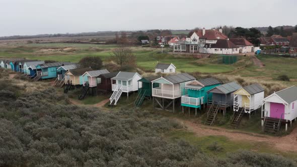 Slider drone shot of colourful beach huts english seaside