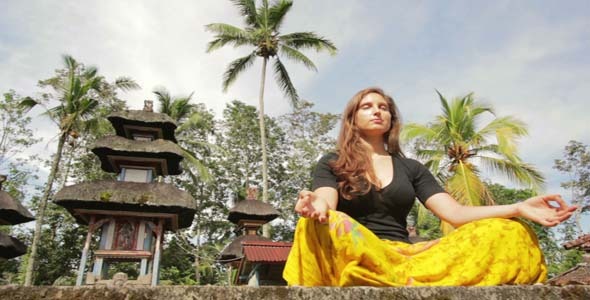 Caucasian Woman Meditating Yoga In Balinese Temple
