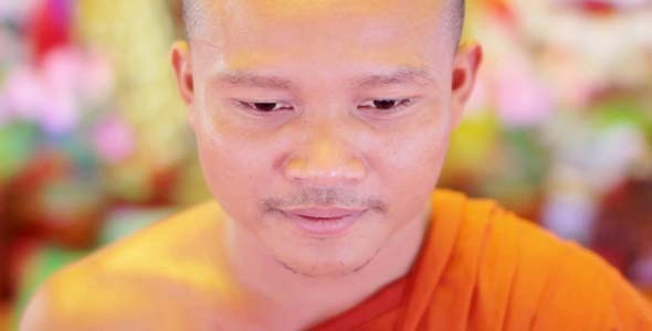 Buddhist Monk With Orange Robe Pray in Temple