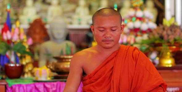 Buddhist Monk With Orange Robe Pray in Temple