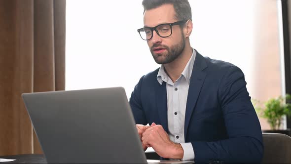 Handsome Businessman is Using Laptop for Video Call