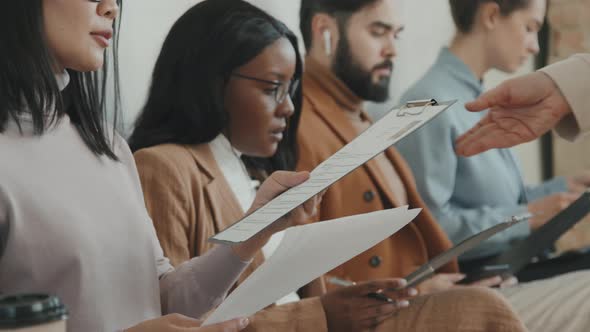 People Receiving Application Forms for Job Interview