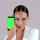Beautiful Asian businesswoman showing smartphone with green screen - VideoHive Item for Sale
