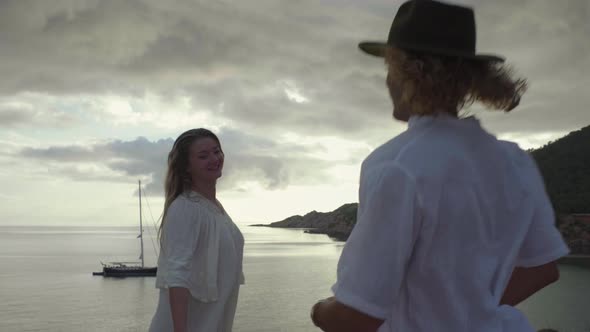 Slow motion shot of couple holding hands and enjoying view