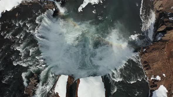 Aerial View of Godafoss Waterfall with Snowy Shore and Ice. Iceland. Winter 2019