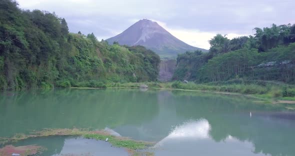 Blue lake surface with Mount Merapi in the background. Bego Pendem is the name of the place for the