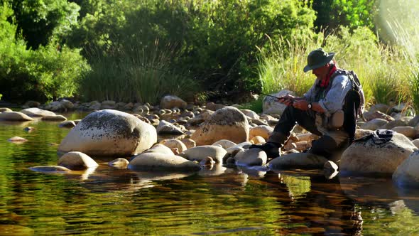 Man fly fishing in river