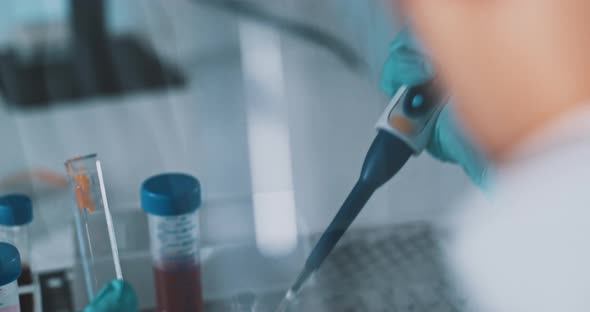 Researcher using a micro pipette in a laboratory