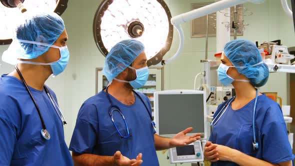 Male and female surgeons interacting with each other in operation room