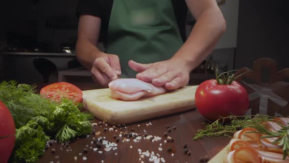 Sliding Zooming Shot: Chef Slices Chicken Fillet on the Kitchen Table, Cooking Meat at Home, Meal