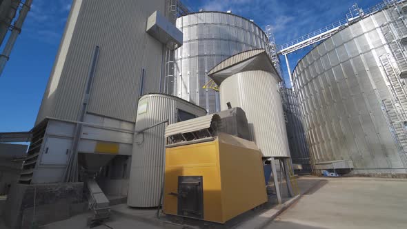 Grain elevator for storage of agricultural crops. Modern silos. Close-up.