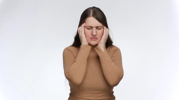 Stressed Young Woman Suffering From Headache Rubbing Her Temples with Hands