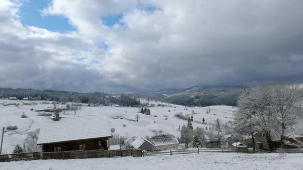 Clouds Move Over the Mountains and the Village in Winter